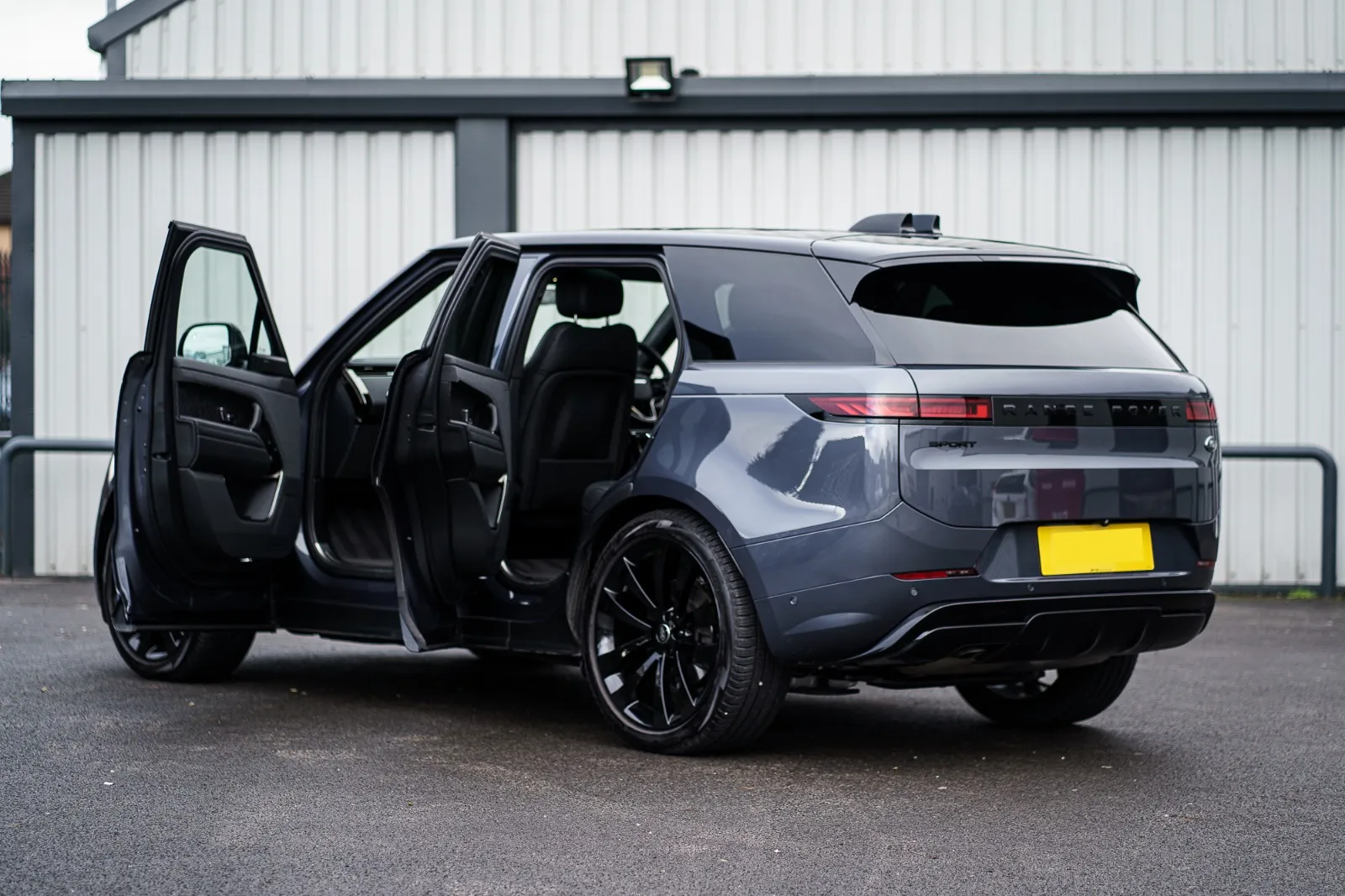 Range Rover Sport with doors open, rear three-quarter view